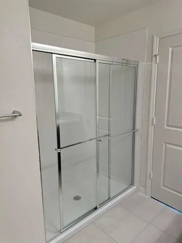 a bathroom with a glass shower door