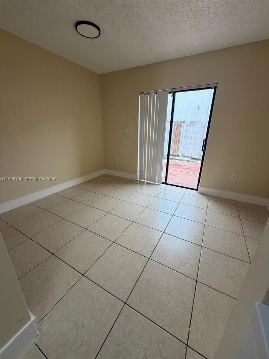 2377 West 66th Place, Unit 204 Hialeah, FL 33016 - Photo 6 of 12 a view of a livingroom with an empty space and a window