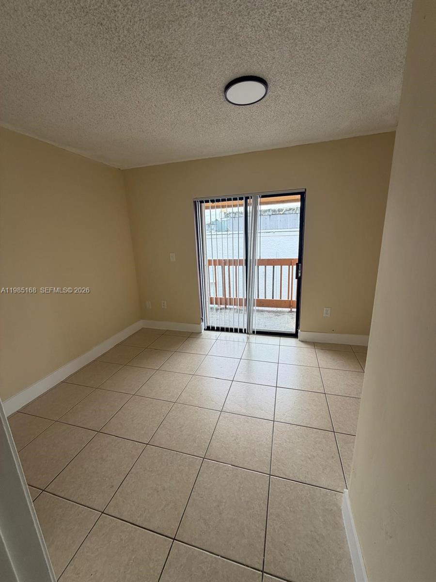 2377 West 66th Place, Unit 204 Hialeah, FL 33016 - Photo 8 of 12 a view of an empty room with a window