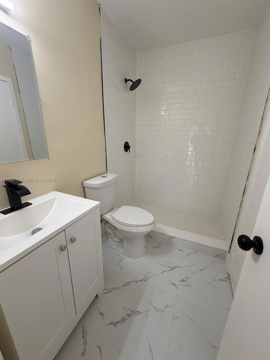 2377 West 66th Place, Unit 204 Hialeah, FL 33016 - Photo 9 of 12 a bathroom with a sink a toilet and shower