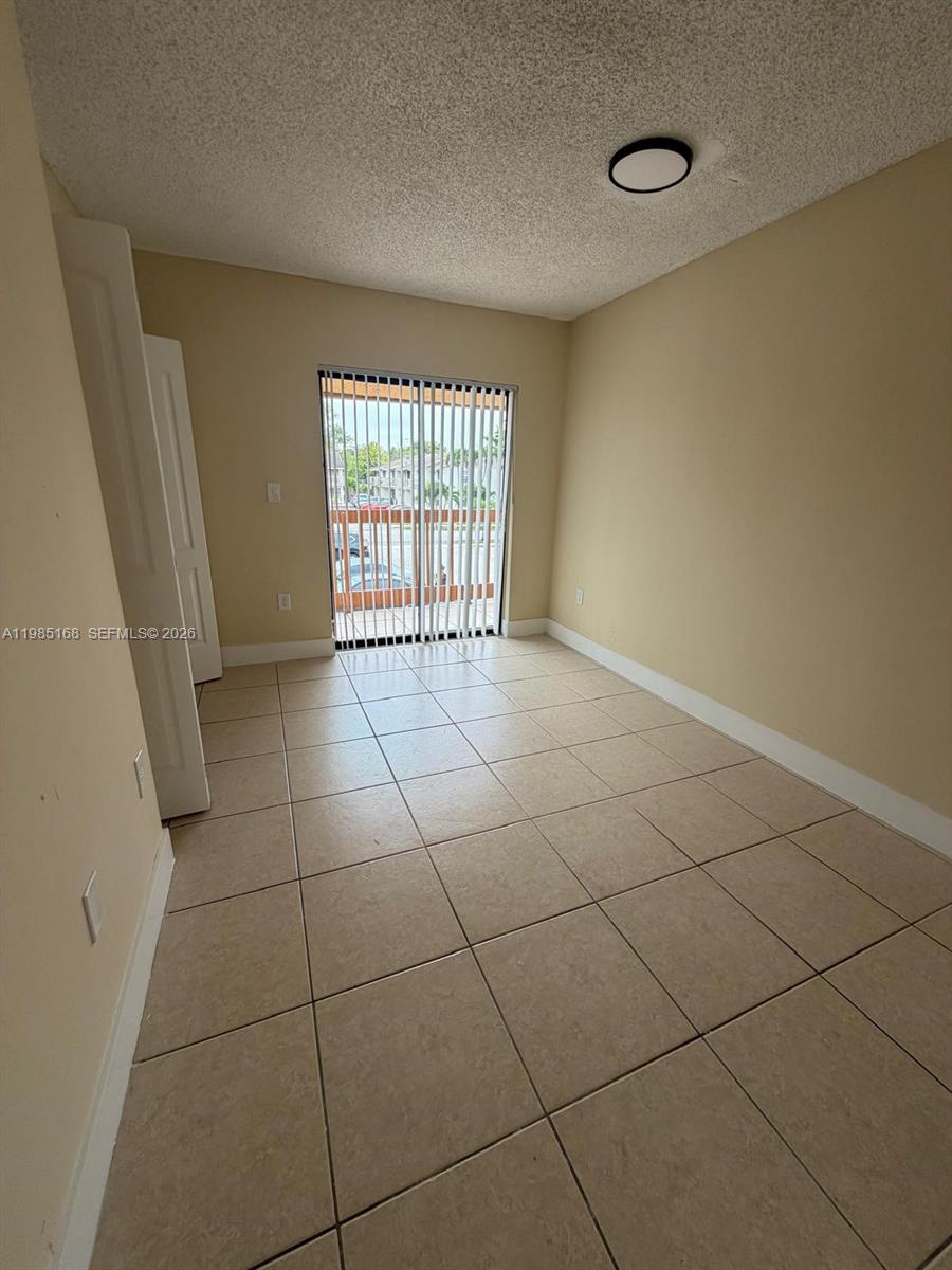 2377 West 66th Place, Unit 204 Hialeah, FL 33016 - Photo 10 of 12 a view of an empty room with a window