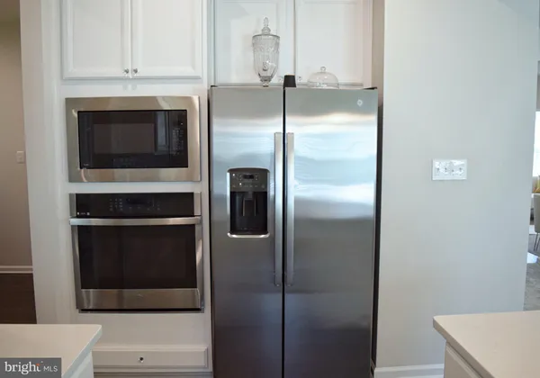 a kitchen with a refrigerator and a stove