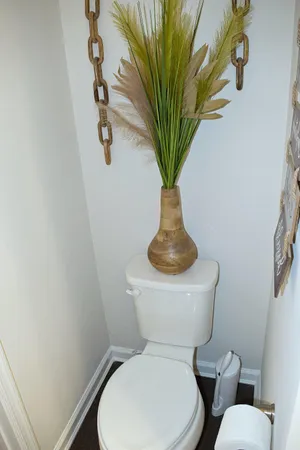a white toilet sitting next to a shower