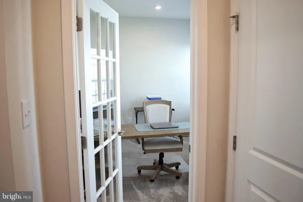a view of a bedroom with a window and workspace