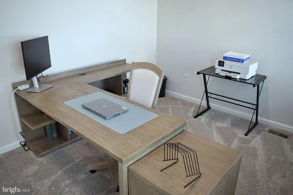 a view of a workspace with furniture