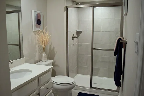 a bathroom with a sink toilet and shower