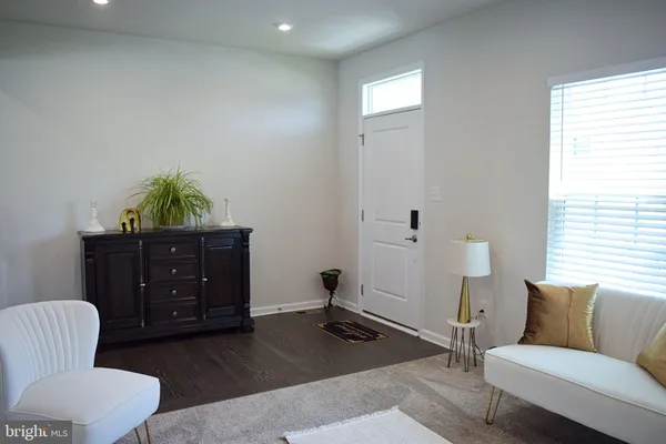 a living room with furniture rug and window