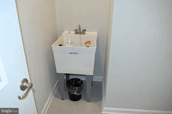 a bathroom with a granite countertop toilet a sink a mirror and shower