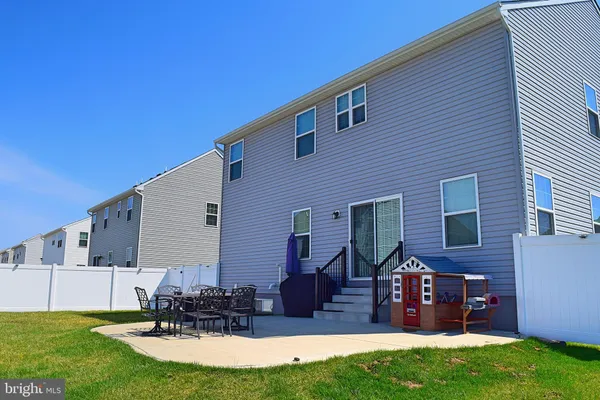 a view of backyard with seating space and trampoline