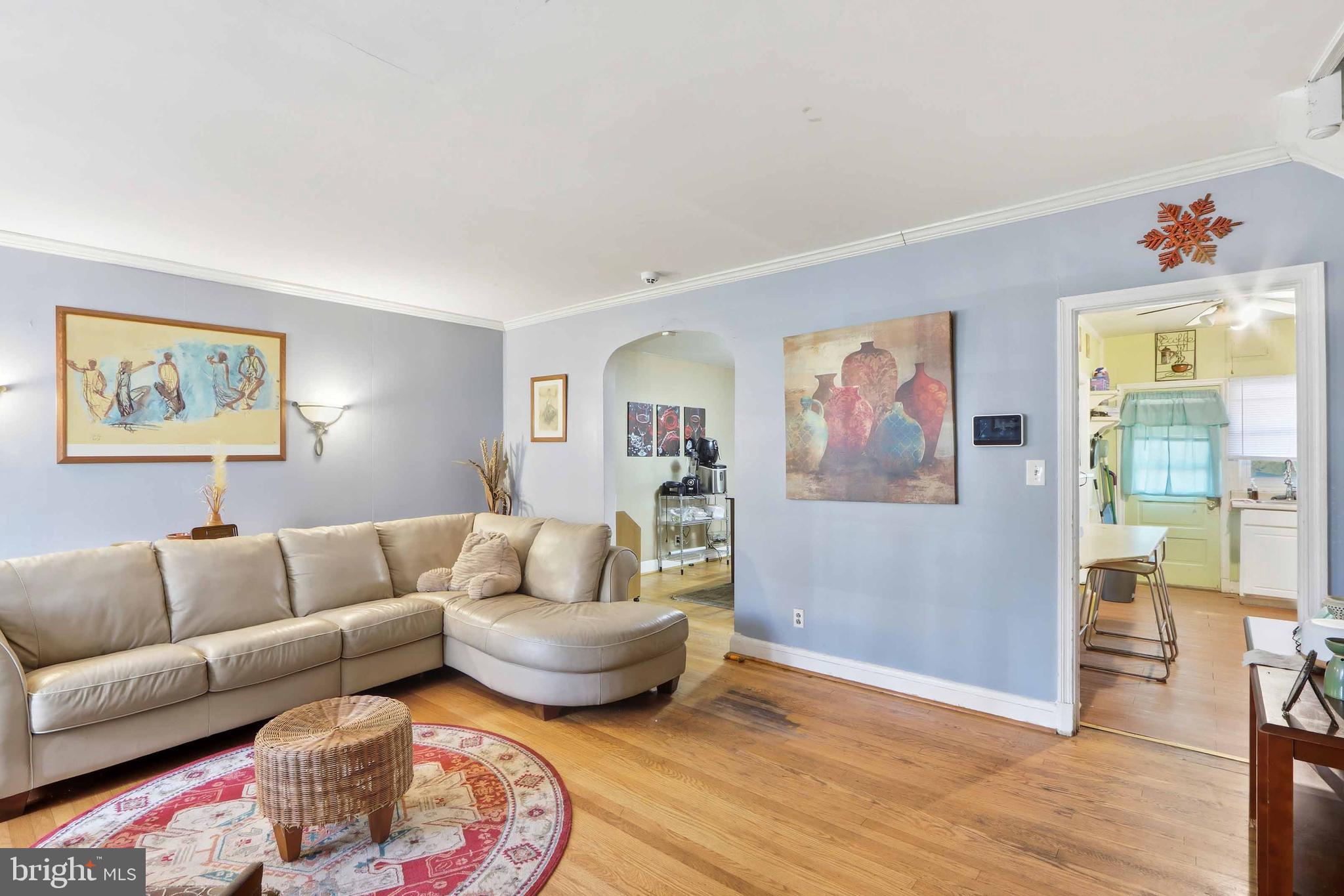 1546 Lochwood Road Baltimore, MD 21218 - Photo 2 of 19 a living room with furniture and wooden floor