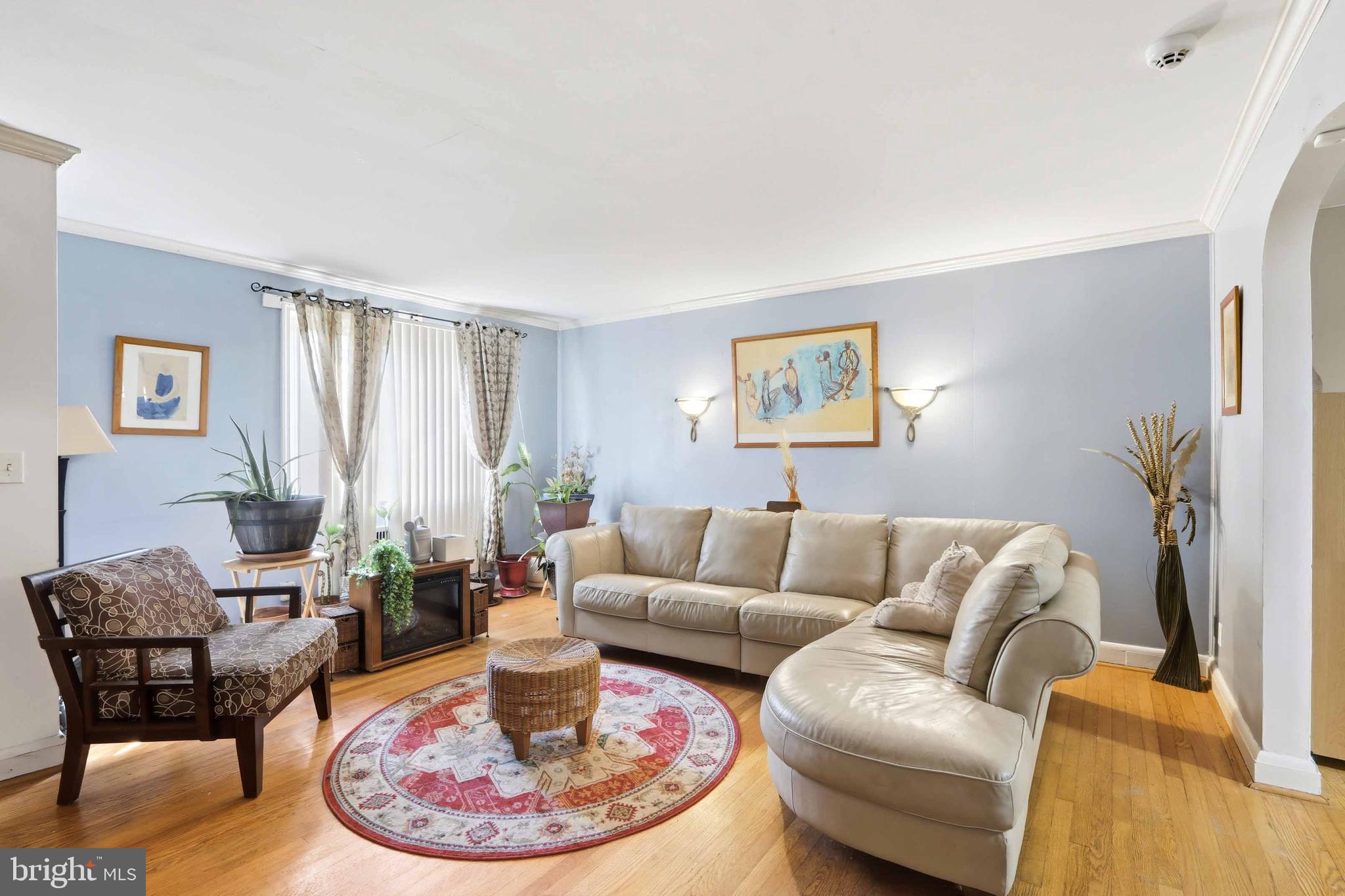 1546 Lochwood Road Baltimore, MD 21218 - Photo 3 of 19 a living room with furniture and a fireplace