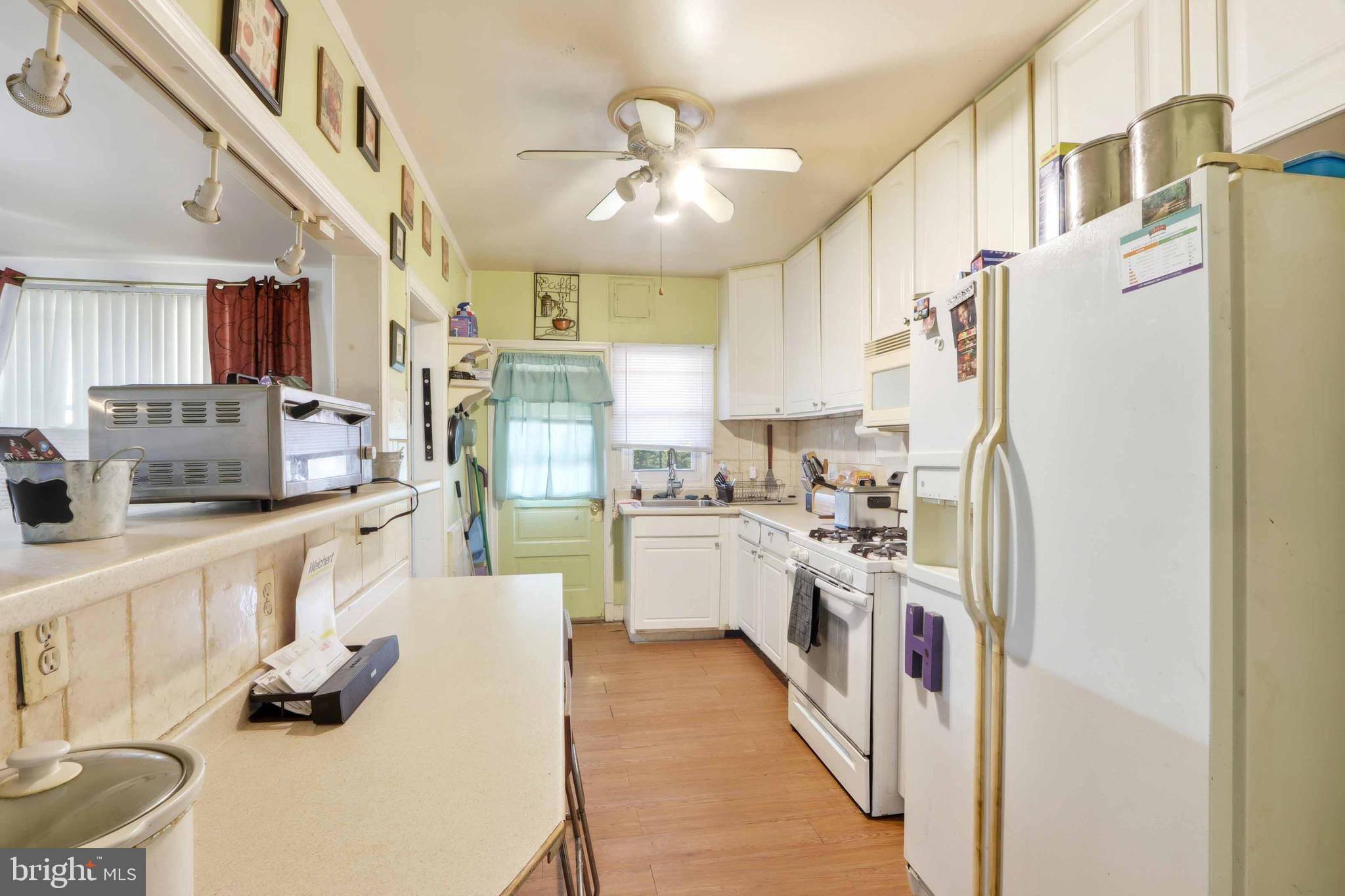 1546 Lochwood Road Baltimore, MD 21218 - Photo 6 of 19 a kitchen with stainless steel appliances a refrigerator sink and cabinets
