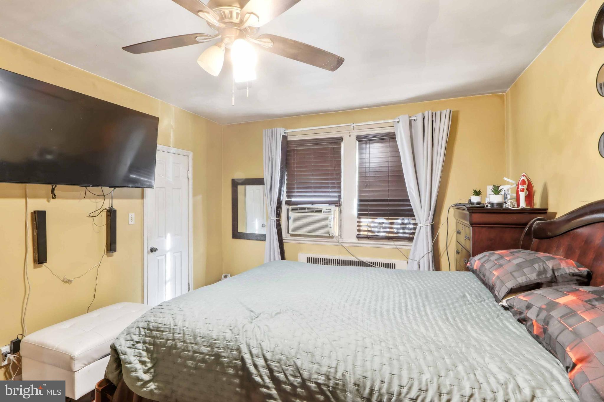 1546 Lochwood Road Baltimore, MD 21218 - Photo 8 of 19 a bedroom with a bed and a flat screen tv