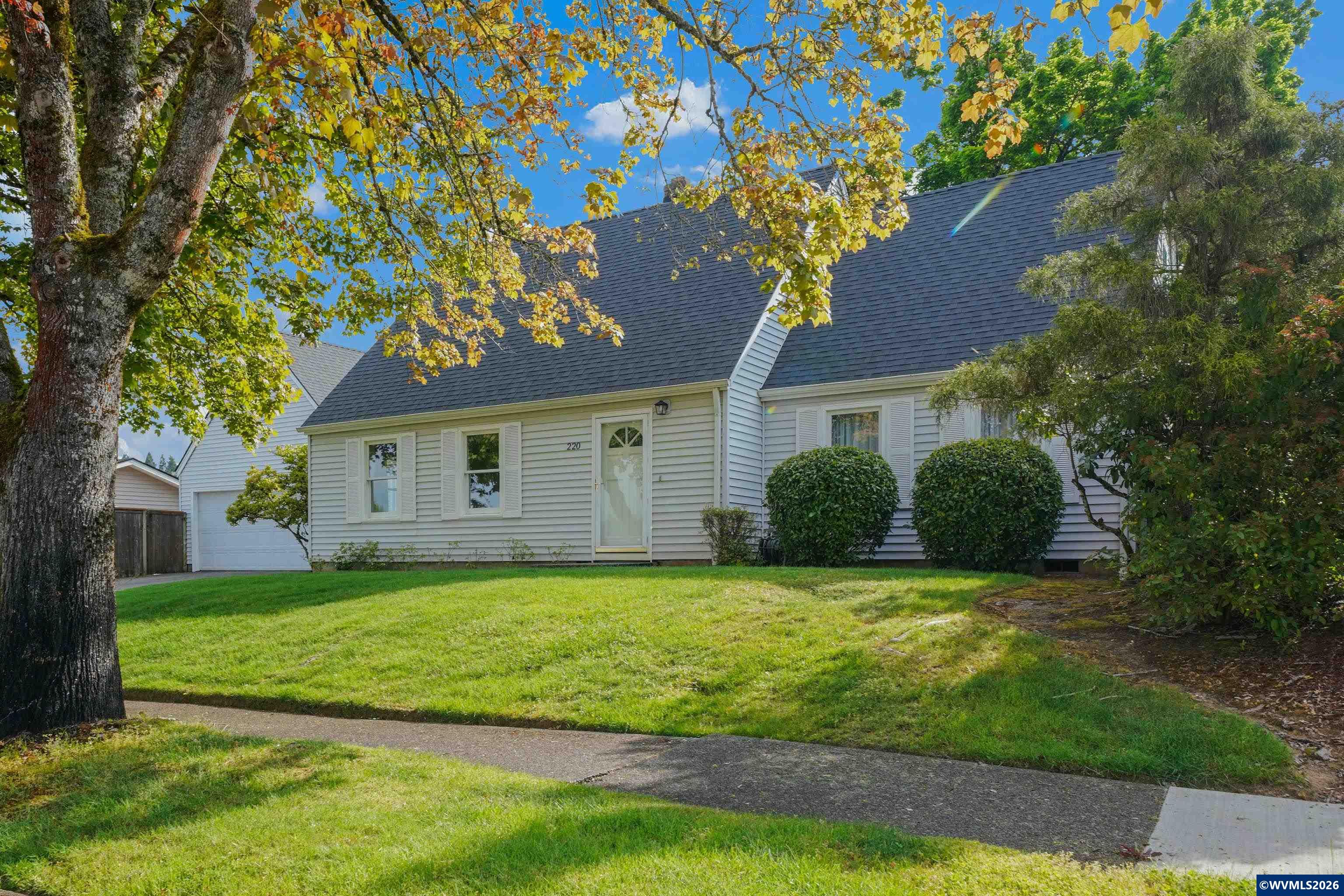 220 Northwest Downy Drive Sublimity, OR 97385 - Photo 2 of 47 a view of a yard in front of a house with a large tree