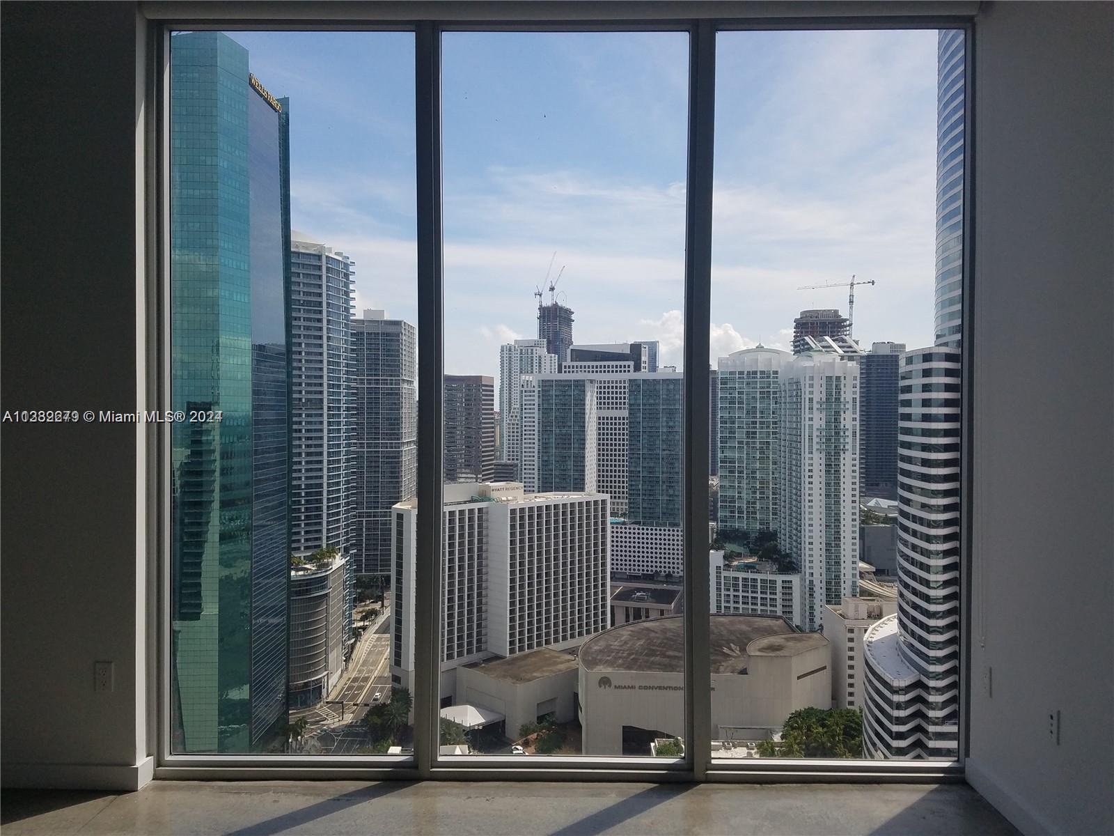 a view of a city from a hallway