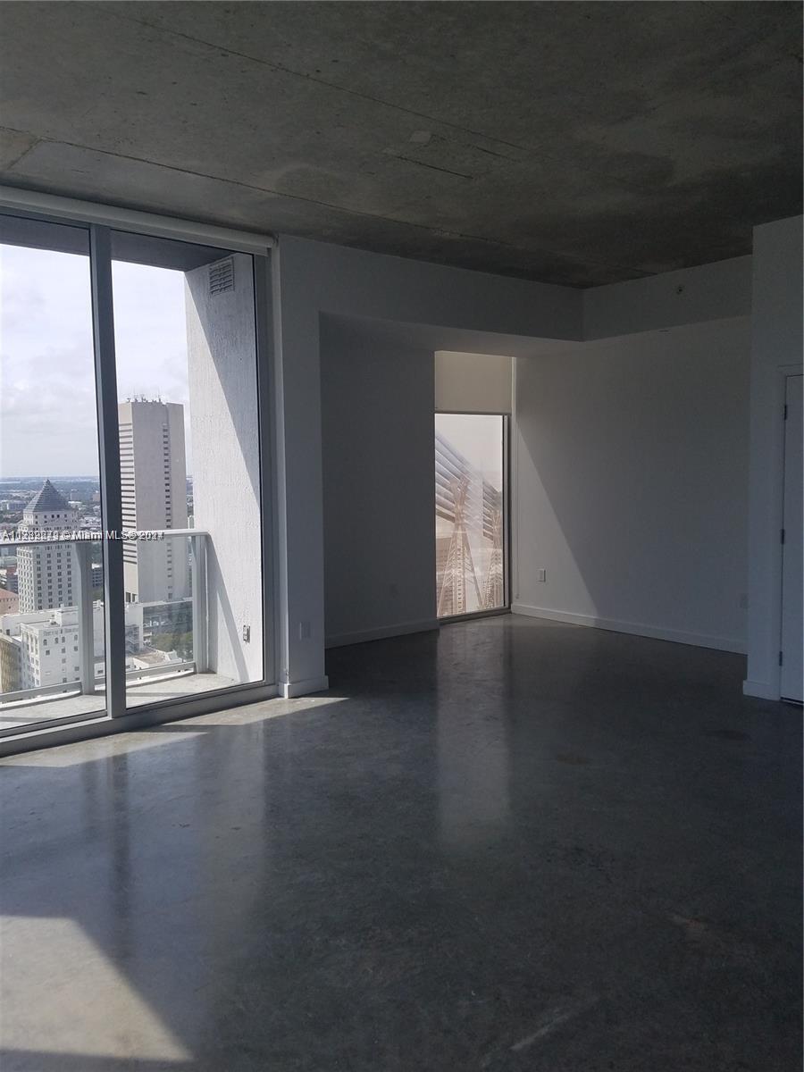 Downtown Miami Miami, FL 33131 - Photo 11 of 26 a view of an empty room with wooden floor and a window
