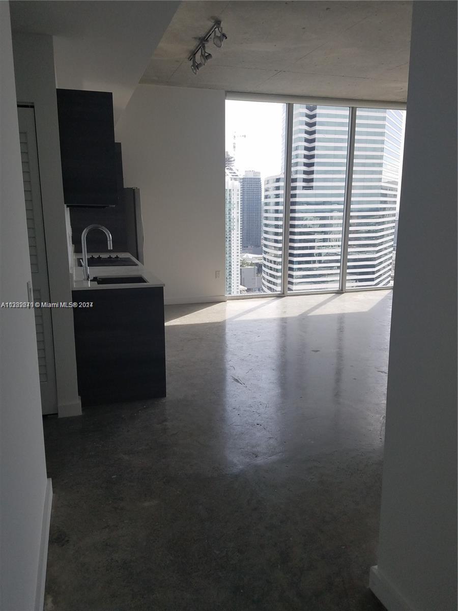Downtown Miami Miami, FL 33131 - Photo 13 of 26 a kitchen with granite countertop a refrigerator and a window