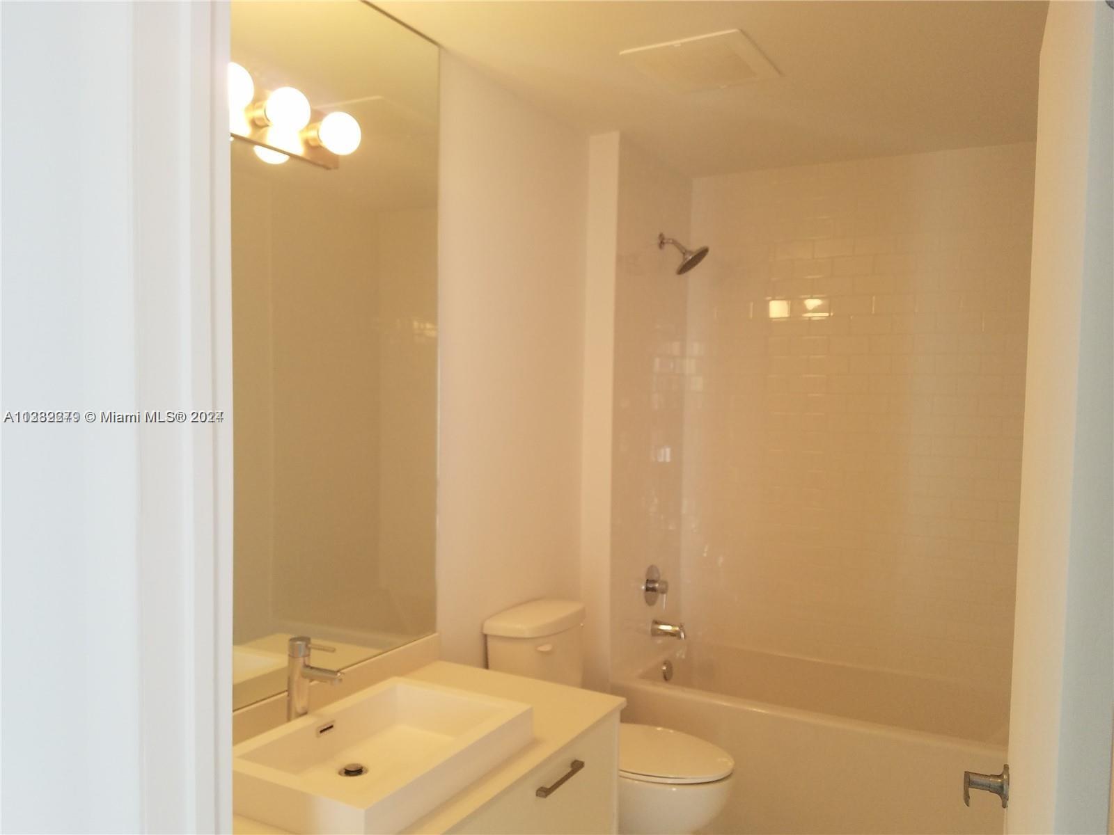 Downtown Miami Miami, FL 33131 - Photo 14 of 26 a bathroom with a sink a toilet and shower