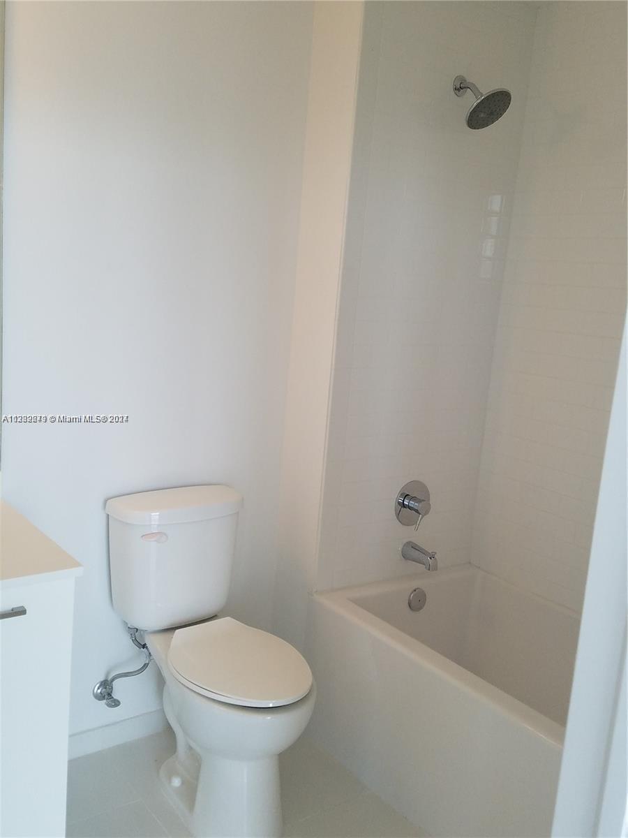 Downtown Miami Miami, FL 33131 - Photo 15 of 26 a white toilet sitting next to a bath tub