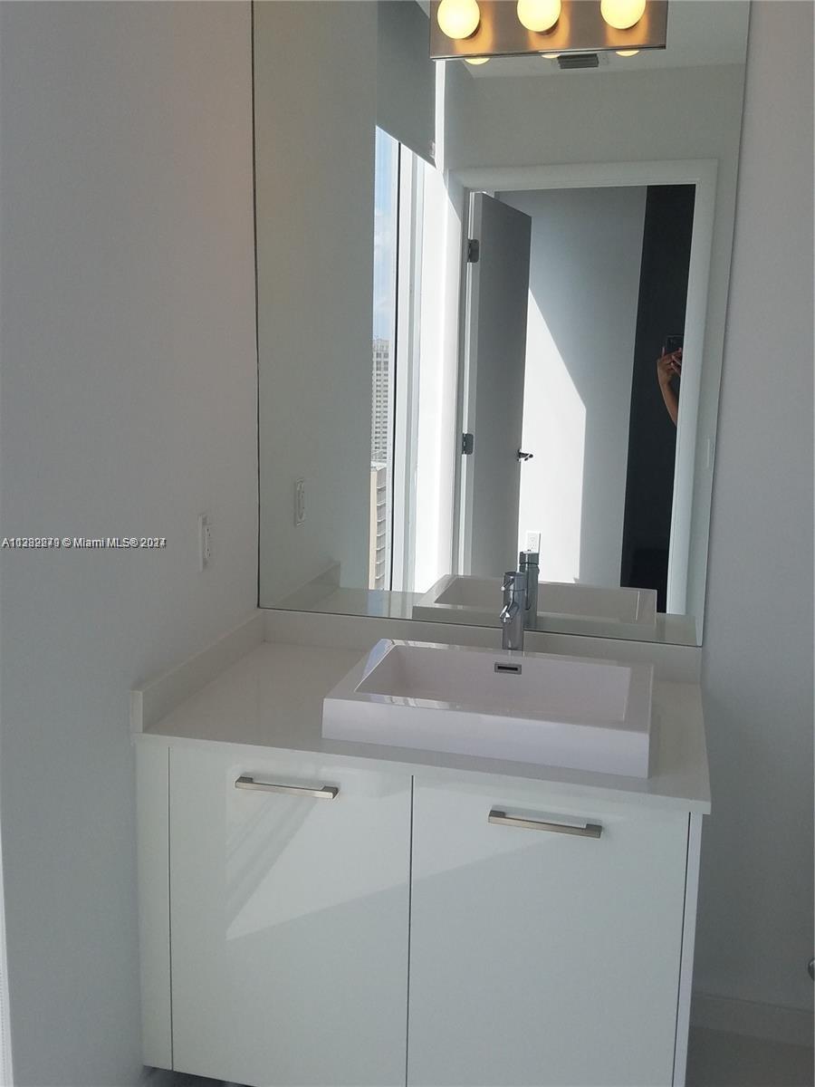 Downtown Miami Miami, FL 33131 - Photo 19 of 26 a bathroom with a sink and a mirror