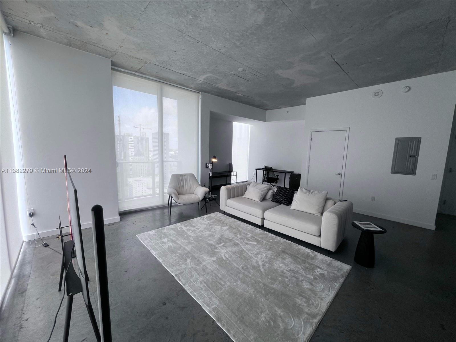 Downtown Miami Miami, FL 33131 - Photo 5 of 26 a living room with furniture and a large window