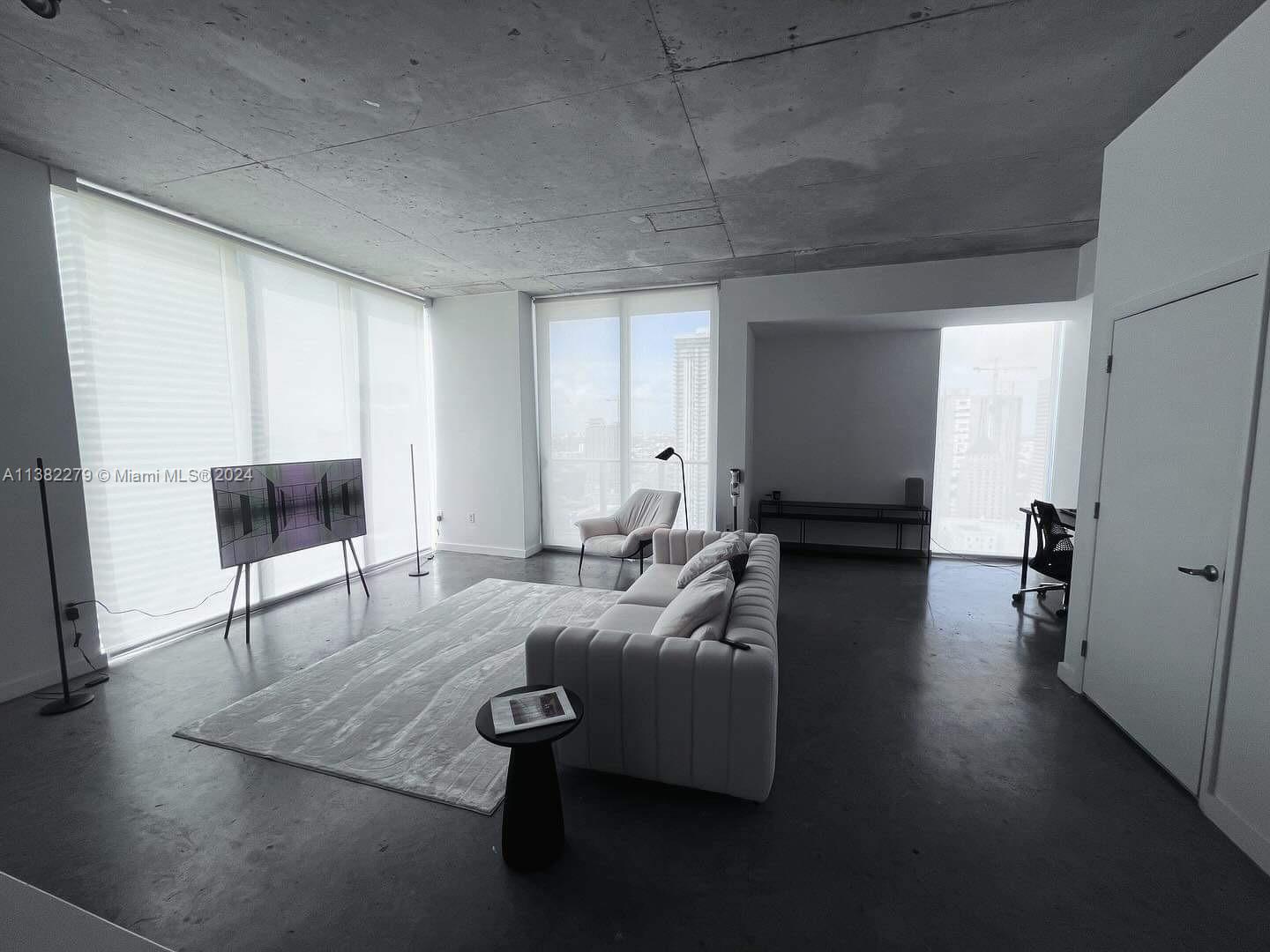 Downtown Miami Miami, FL 33131 - Photo 6 of 26 a living room with furniture and a couch