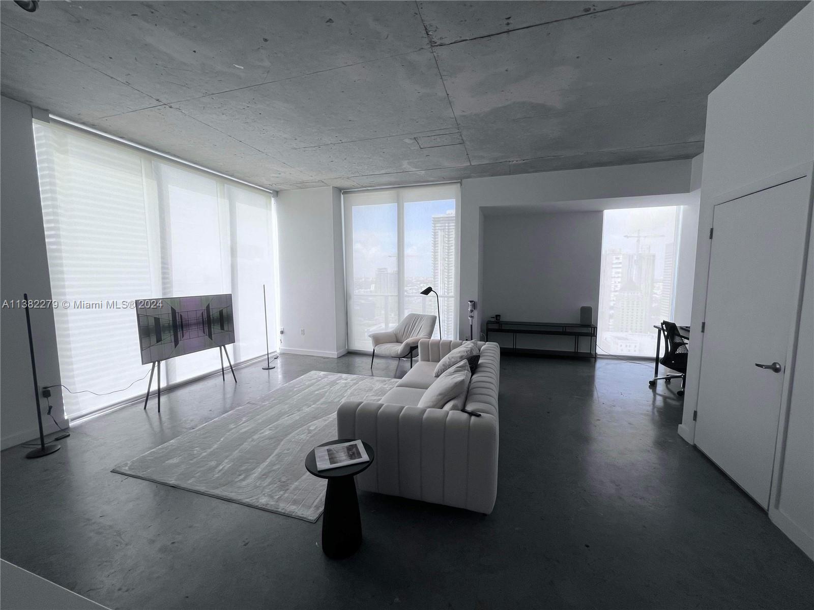 Downtown Miami Miami, FL 33131 - Photo 7 of 26 a living room with furniture and a couch