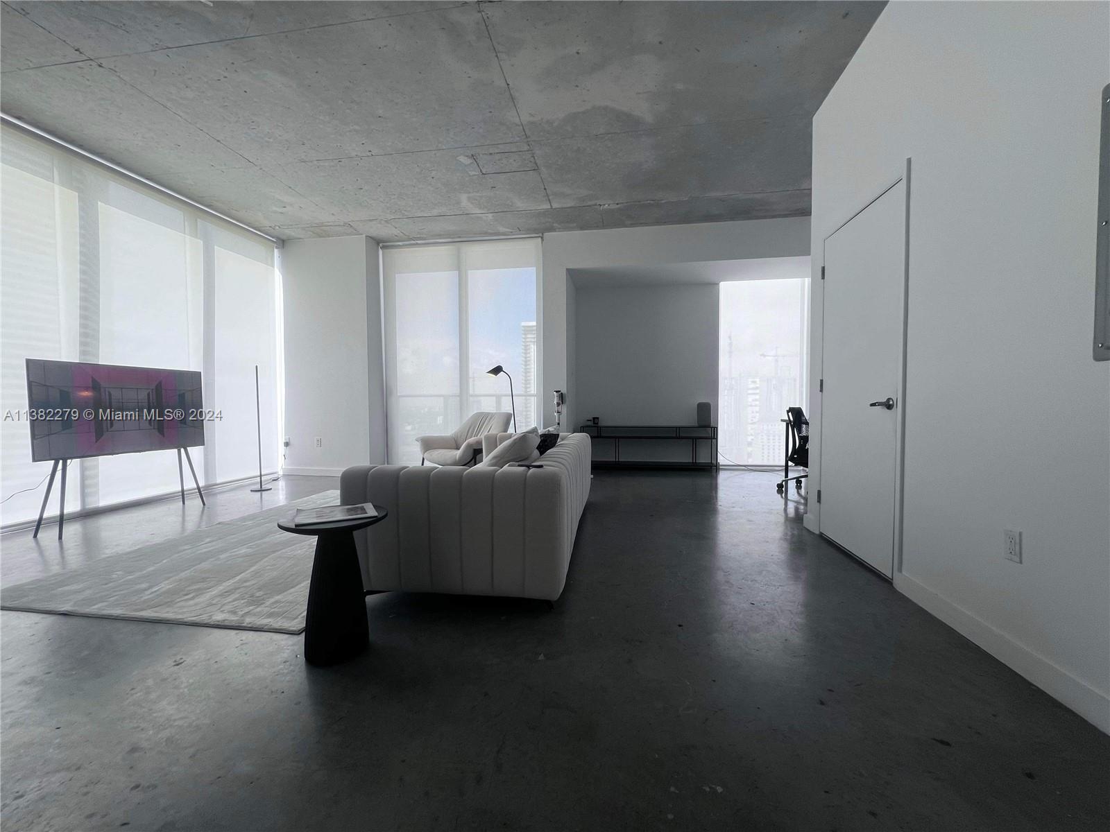 Downtown Miami Miami, FL 33131 - Photo 8 of 26 a living room with furniture and a window