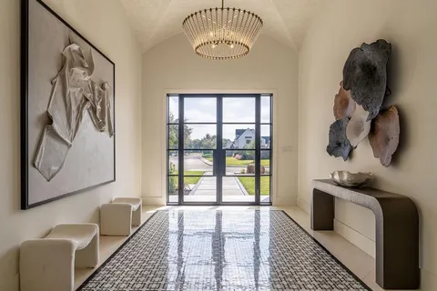 a bathroom with a tub and a large window