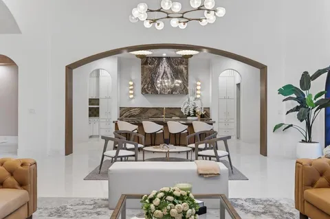 a living room with furniture and a chandelier