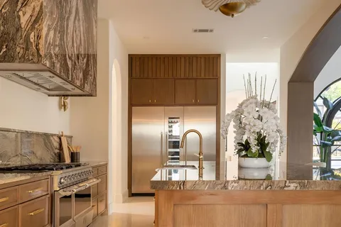 a kitchen with a sink cabinets and stove top oven