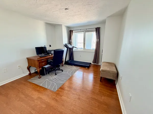 a living room with furniture and a piano