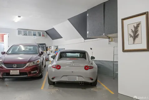 a bedroom with a bed and a car