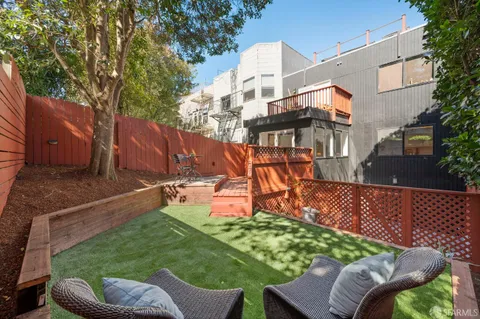 a view of a patio with couches table and chairs and potted plants
