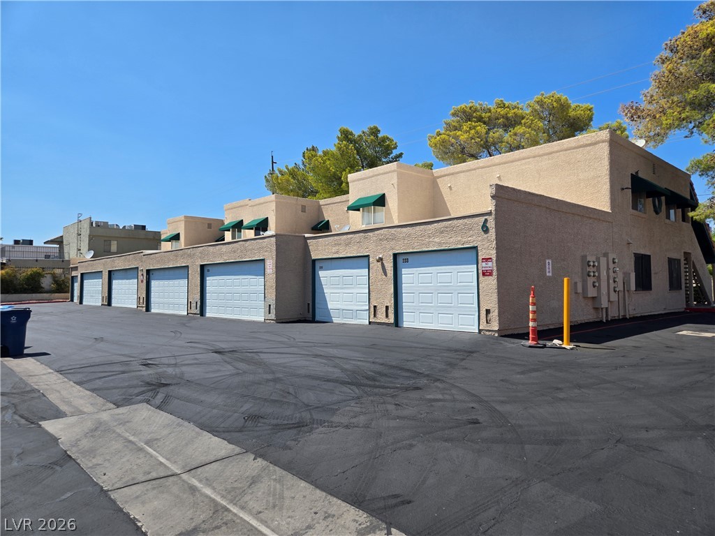 Functional garage doors provide convenient vehicle storage for each unit.