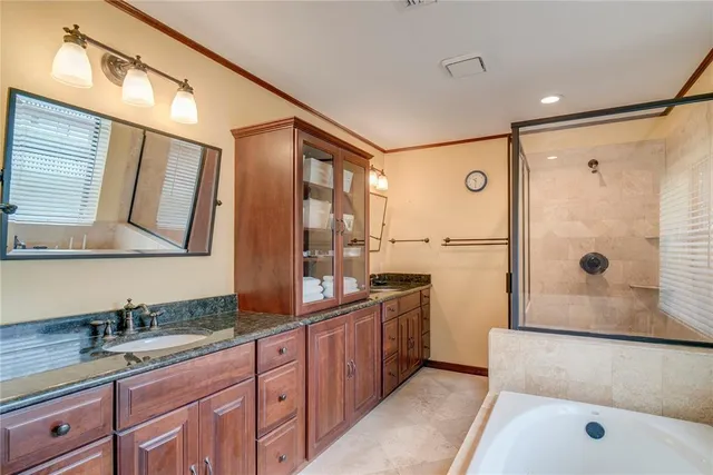 a bathroom with a tub and a shower