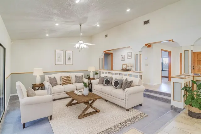 a view of a dining room with furniture and chandelier