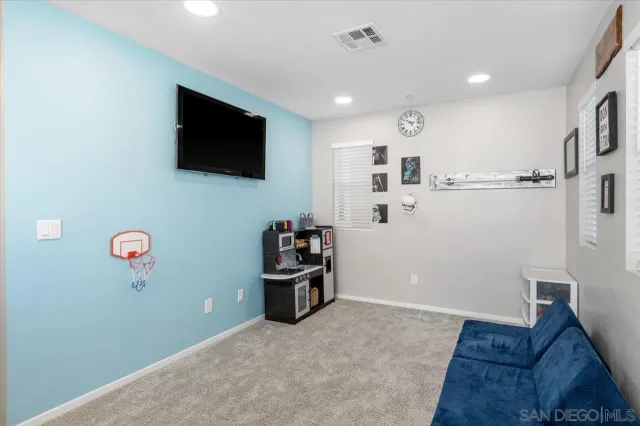 a bedroom with a bed and a ceiling fan