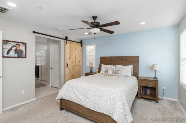 a view of walk in closet with clothes