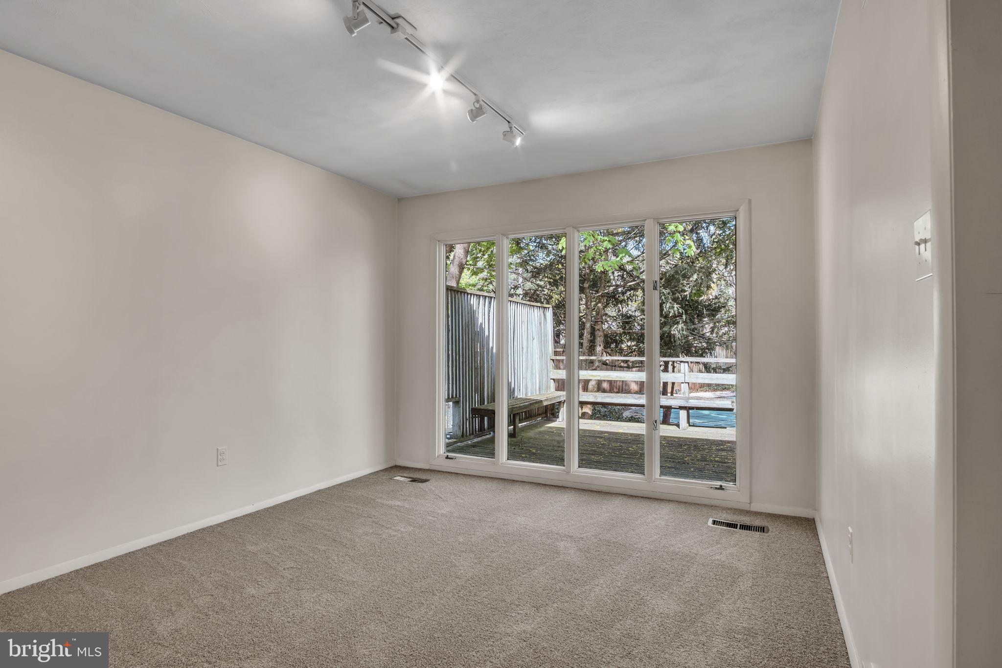 4536 Custer Drive Harrisburg, PA 17110 - Photo 13 of 53 an empty room with large windows and a fireplace