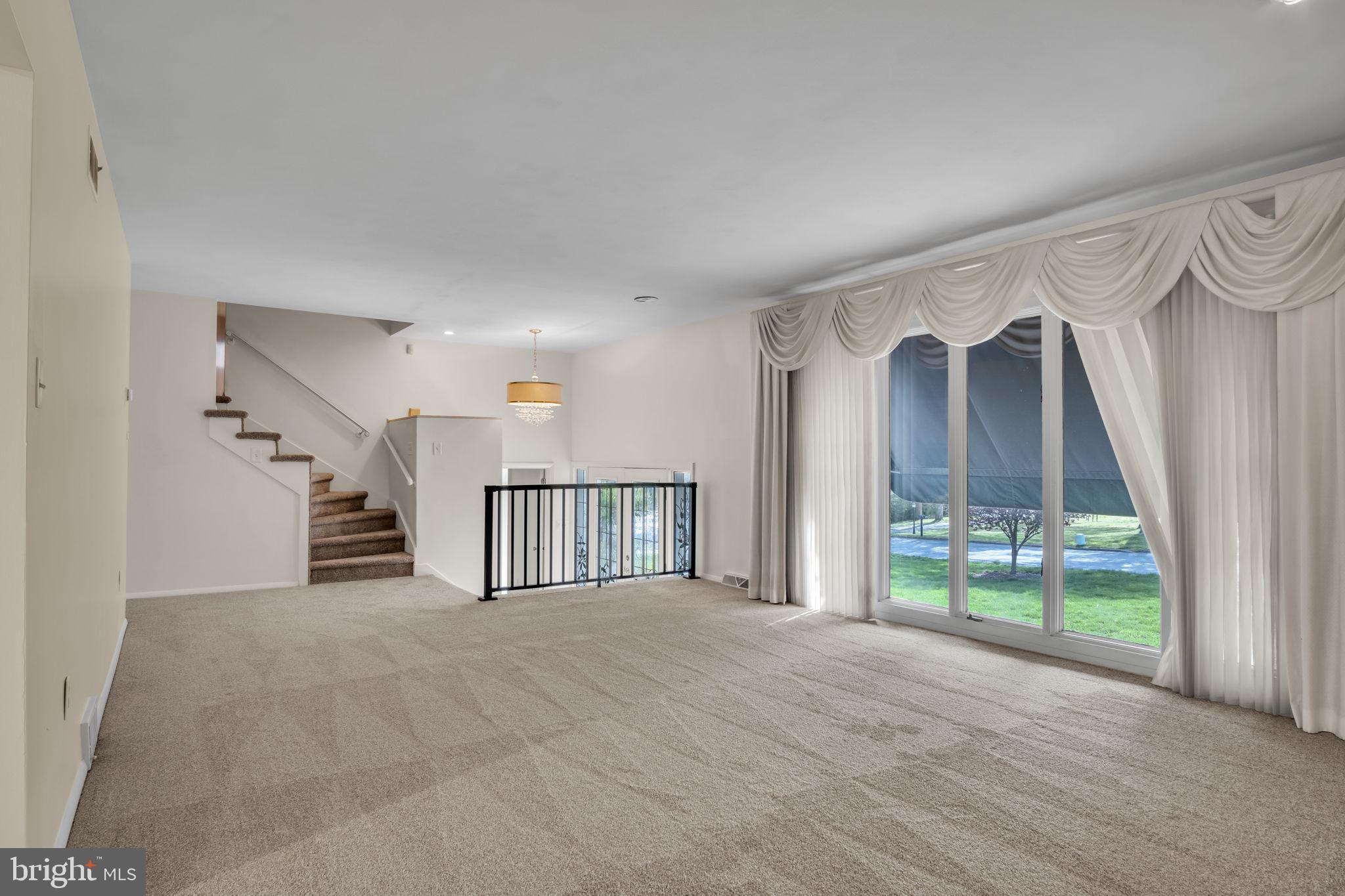 4536 Custer Drive Harrisburg, PA 17110 - Photo 8 of 53 a view of an empty room with a fireplace and a window