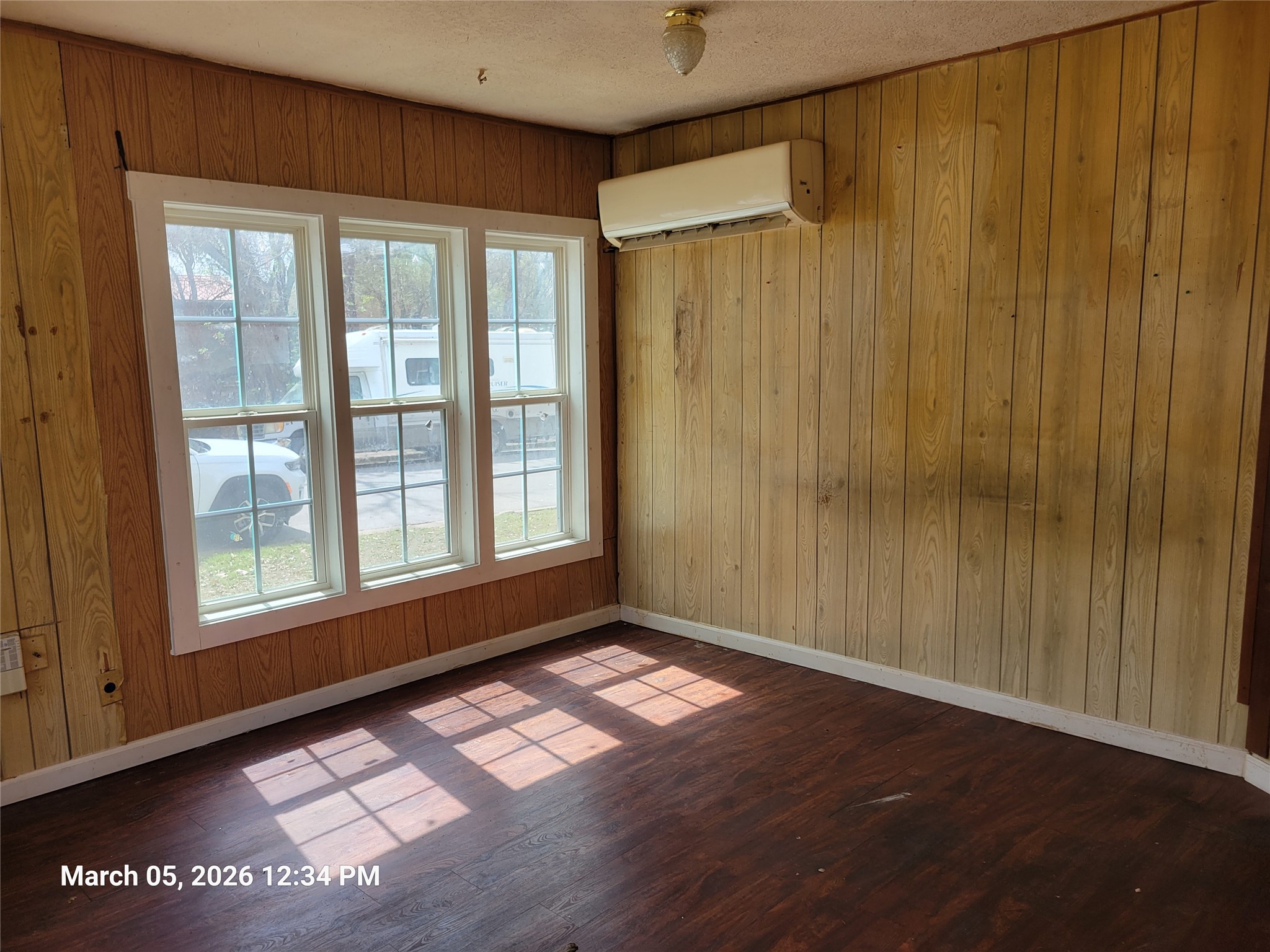 2000 Alamo Street Austin, TX 78722 - Photo 4 of 8 a view of an empty room with a window and hardwood floor