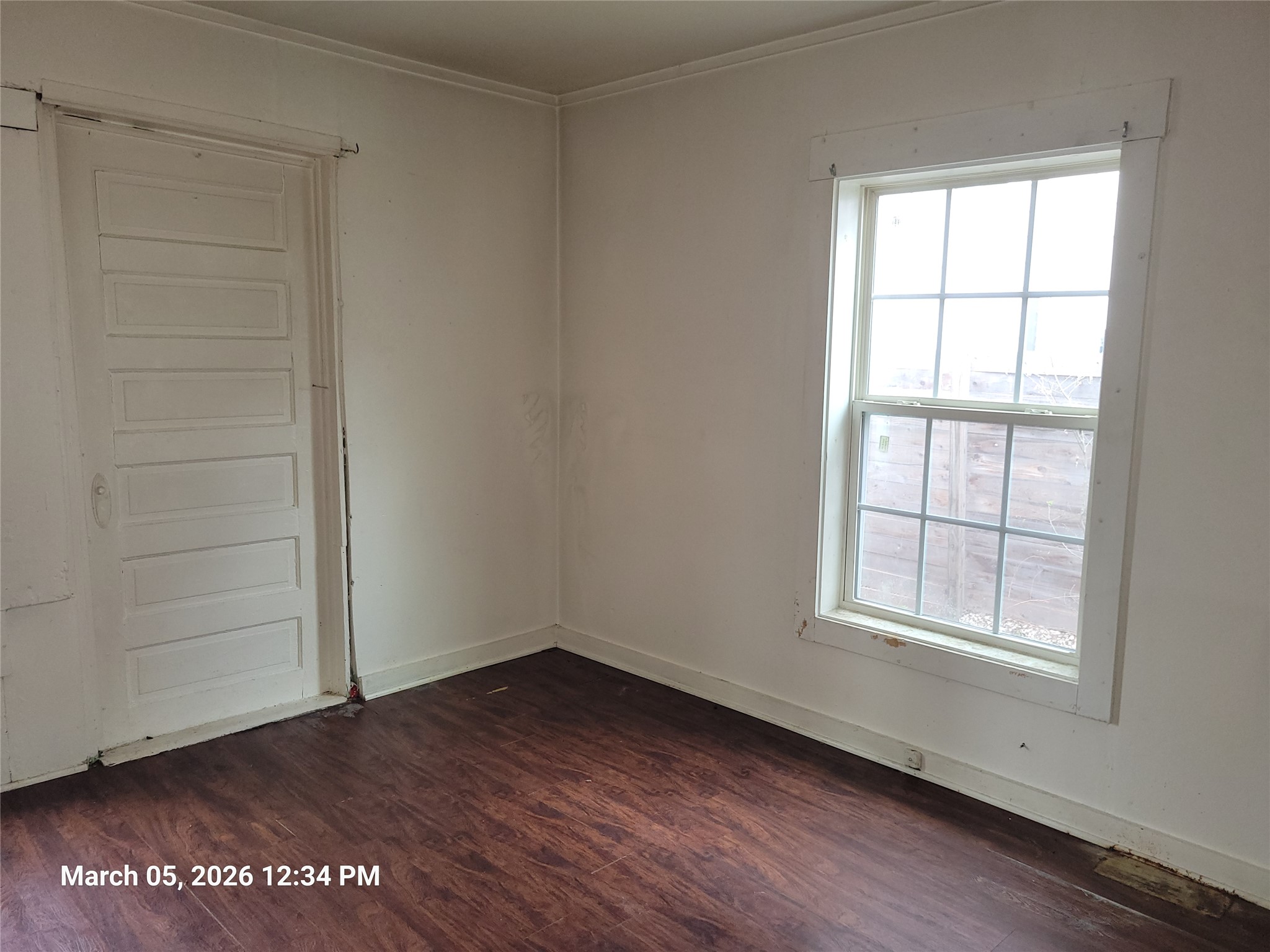 2000 Alamo Street Austin, TX 78722 - Photo 7 of 8 an empty room with wooden floor and window
