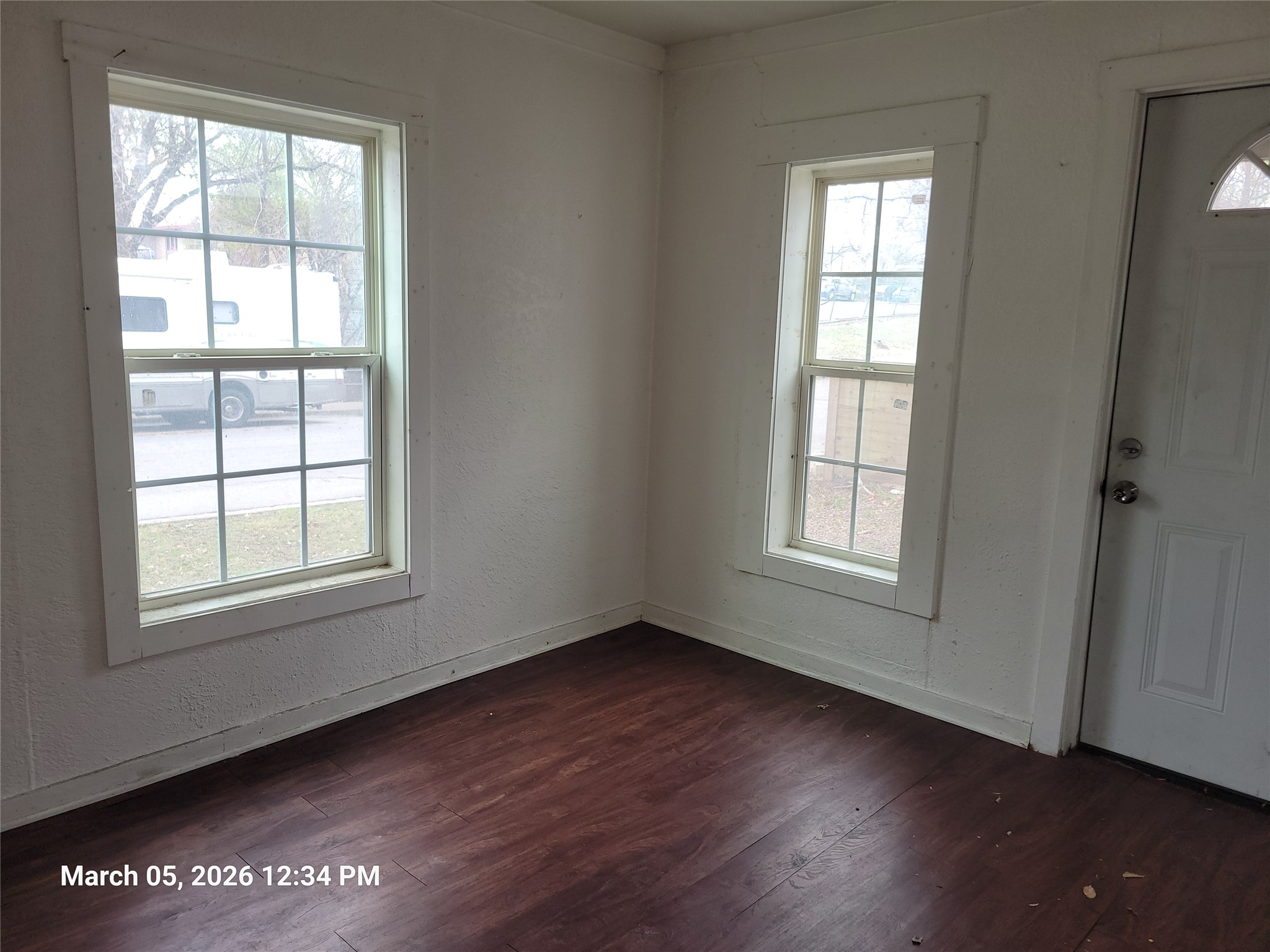 2000 Alamo Street Austin, TX 78722 - Photo 8 of 8 an empty room with wooden floor and windows