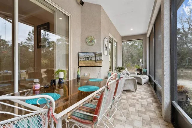 a view of a house with backyard and tree