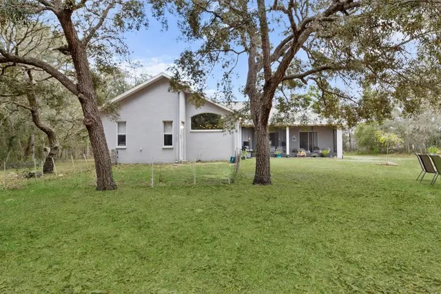 a front view of a house with a yard and a garage