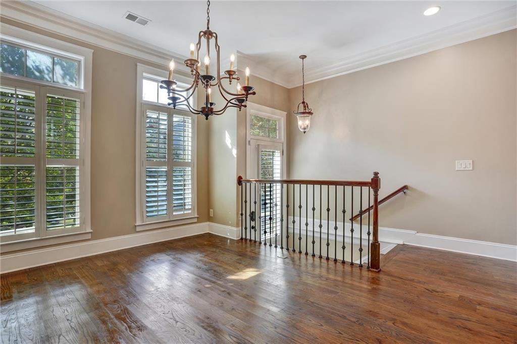 2443 Gatebury Circle Atlanta, GA 30341 - Photo 12 of 45 a view of a room with wooden floor chandelier and windows