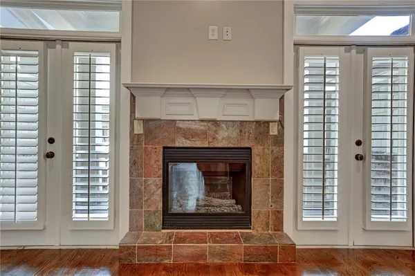a living room with a fireplace and windows