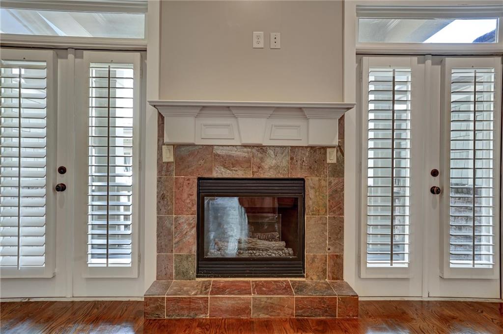 2443 Gatebury Circle Atlanta, GA 30341 - Photo 18 of 45 a living room with a fireplace and windows