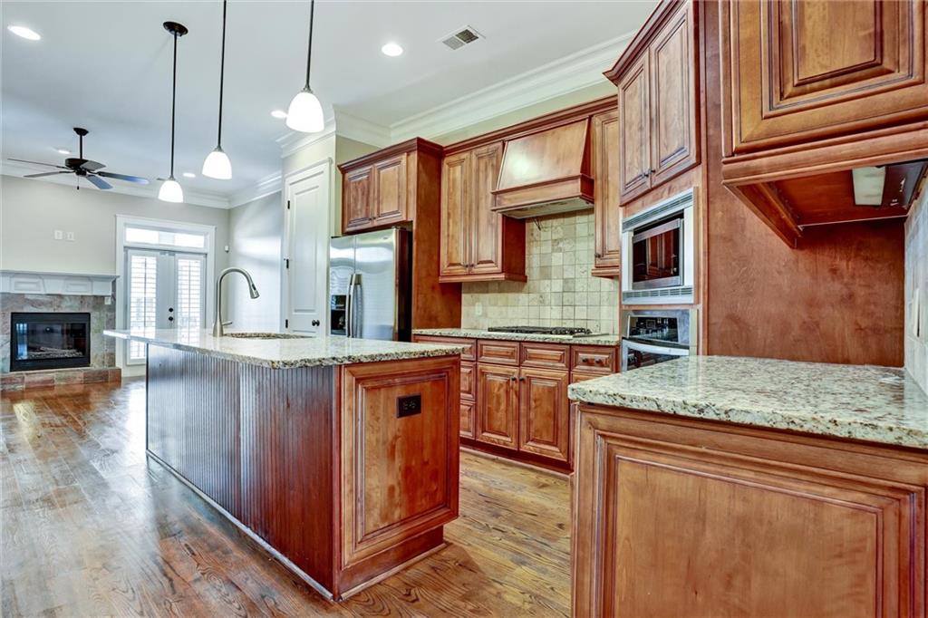 2443 Gatebury Circle Atlanta, GA 30341 - Photo 20 of 45 a kitchen with stainless steel appliances granite countertop a stove a sink and a refrigerator